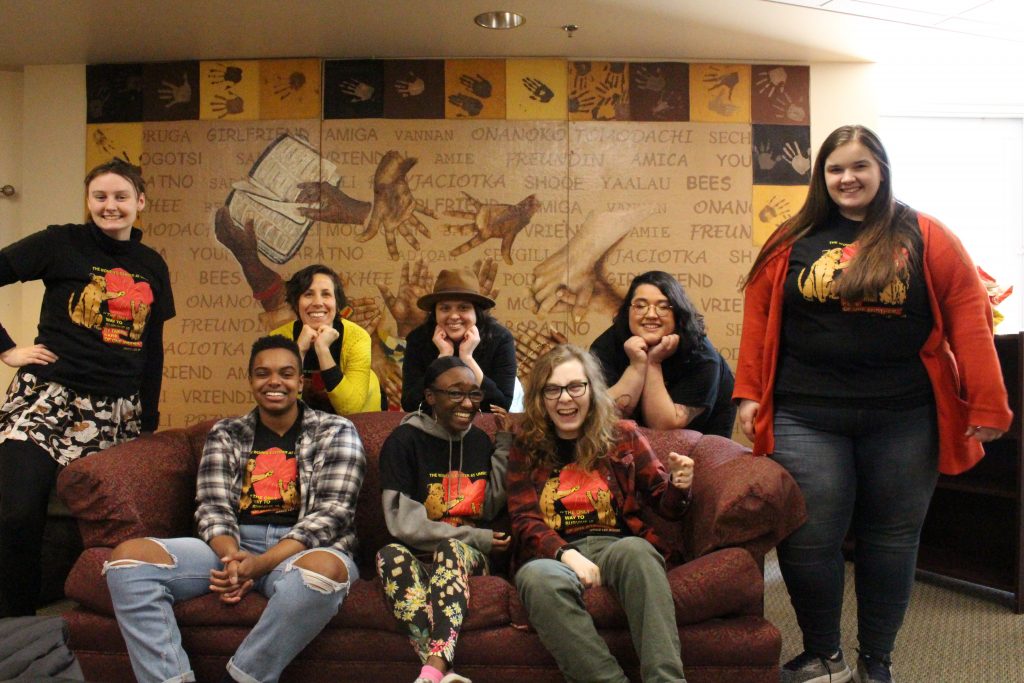 The Women's Center staff seated on a couch and standing behind couch