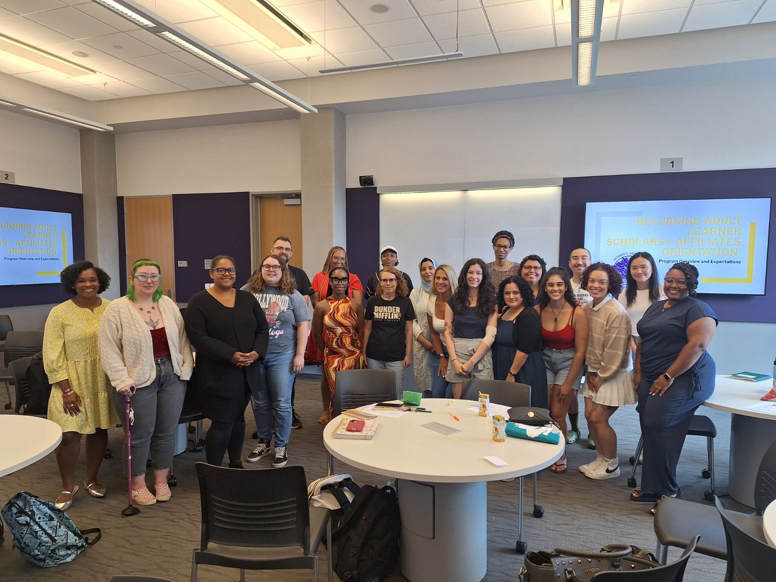 Returning Adult Learners and Women's, Gender, and Equity Center staff smile for a group picture. 